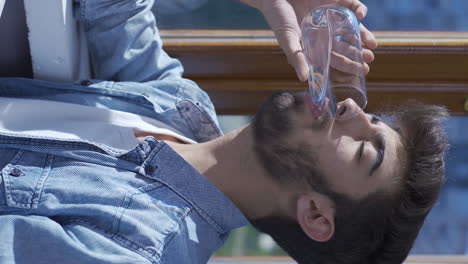 Vertical-video-of-The-man-who-drinks-water.